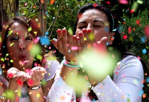 Ladies blowing confetti